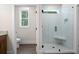 Bathroom with glass enclosed shower with seating and views of the exterior landscape at 160 Doris Path, Dallas, GA 30157