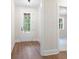 Bright entryway with wood-look flooring and a modern glass-paneled front door at 160 Doris Path, Dallas, GA 30157