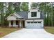 Inviting home with a white exterior, a two-car garage, and a spacious concrete driveway at 160 Doris Path, Dallas, GA 30157