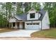 Home's exterior featuring a two-car garage and a well-manicured lawn at 160 Doris Path, Dallas, GA 30157