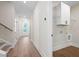 Light and airy hallway view showcasing the home's flooring, doors, and laundry room space at 160 Doris Path, Dallas, GA 30157