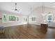 Open-concept living area with hardwood floors, a stone fireplace, and bright natural light at 160 Doris Path, Dallas, GA 30157