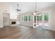 Open living room features a stone fireplace, vaulted ceilings, wood floors, and a view to the exterior at 160 Doris Path, Dallas, GA 30157