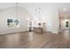 Open-concept living space showcasing a modern kitchen, wood flooring, and natural light at 160 Doris Path, Dallas, GA 30157