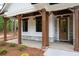 Inviting front porch with stone accents, wooden columns, and stylish outdoor lighting at 160 Doris Path, Dallas, GA 30157