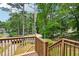 A view from an elevated deck shows a grassy backyard with mature trees and distant homes at 187 Timber Creek Sw Ln, Marietta, GA 30060