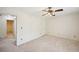 Bedroom featuring neutral carpet, a ceiling fan, and easy access to a bathroom at 187 Timber Creek Sw Ln, Marietta, GA 30060