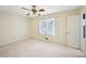 Bright bedroom featuring a ceiling fan, window, and a doorway, offering ample space and natural light at 187 Timber Creek Sw Ln, Marietta, GA 30060