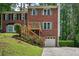 Charming brick home featuring a wooden deck, lush green lawn, and convenient garage access at 187 Timber Creek Sw Ln, Marietta, GA 30060