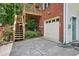 Brick home exterior with attached garage, wood deck, stairs, and lush greenery at 187 Timber Creek Sw Ln, Marietta, GA 30060