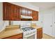 Kitchen showcases a white gas range with dark wood cabinets and white countertop space at 187 Timber Creek Sw Ln, Marietta, GA 30060