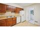 Classic kitchen featuring wood cabinets, laminate countertops, and white appliances in a cozy design at 187 Timber Creek Sw Ln, Marietta, GA 30060