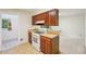 Efficient kitchen featuring wood cabinetry, vinyl flooring and an adjacent dining room at 187 Timber Creek Sw Ln, Marietta, GA 30060