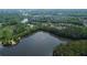 Breathtaking aerial view showcasing a large lake surrounded by lush trees and residential neighborhoods at 238 Harmony Lake Dr, Canton, GA 30115
