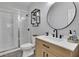 Clean bathroom featuring a glass enclosed shower, a stylish round mirror, and modern fixtures at 238 Harmony Lake Dr, Canton, GA 30115