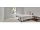 Bright bedroom features a large window, neutral carpet, and contemporary furnishings at 238 Harmony Lake Dr, Canton, GA 30115