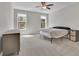 A bright bedroom with two windows, neutral walls, carpet, and a ceiling fan at 238 Harmony Lake Dr, Canton, GA 30115