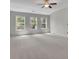 Spacious bedroom featuring a ceiling fan, carpet, and natural light from three windows at 238 Harmony Lake Dr, Canton, GA 30115