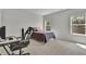 A bedroom featuring neutral walls, a window, and a desk with a gaming chair at 238 Harmony Lake Dr, Canton, GA 30115