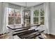 Charming breakfast nook featuring a wooden table, benches, and large windows offering a view of the outdoors at 238 Harmony Lake Dr, Canton, GA 30115
