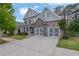 Beautiful home featuring a stone and siding exterior, complemented by a well-manicured lawn and a spacious driveway at 238 Harmony Lake Dr, Canton, GA 30115