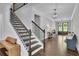 Grand foyer with hardwood floors, a staircase with iron railings, and a view of the front entrance at 238 Harmony Lake Dr, Canton, GA 30115