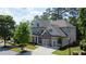 Charming two-story home with a well-manicured lawn, mature trees, and a two-car garage at 238 Harmony Lake Dr, Canton, GA 30115