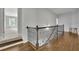 A bright upstairs hallway with wood floors and an iron railing at 238 Harmony Lake Dr, Canton, GA 30115