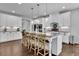 A gourmet kitchen featuring a large center island with granite countertops and stainless steel appliances at 238 Harmony Lake Dr, Canton, GA 30115