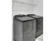 Modern laundry room with front load washer and dryer and wire shelving at 238 Harmony Lake Dr, Canton, GA 30115