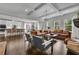 Open-concept living room with hardwood floors, coffered ceilings, a fireplace, and seamless flow to the kitchen at 238 Harmony Lake Dr, Canton, GA 30115
