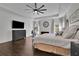Spacious main bedroom has hardwood floors, ceiling fan, and large screen television at 238 Harmony Lake Dr, Canton, GA 30115