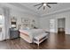 Bright main bedroom showcases hardwood floors, ceiling fan, and bench at 238 Harmony Lake Dr, Canton, GA 30115