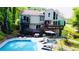 Back of house and pool with lounge chairs at 3748 Woodrose Ct, Snellville, GA 30039