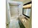 Bathroom features a shower-tub combination, vanity, modern lighting, and tiled floors with a skylight at 3748 Woodrose Ct, Snellville, GA 30039