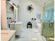 Modern bathroom featuring double vanity, glass enclosed shower, and luxurious soaking tub at 3748 Woodrose Ct, Snellville, GA 30039