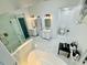 Modern bathroom offers dual sinks, a glass-enclosed shower, and a soaking tub for ultimate comfort at 3748 Woodrose Ct, Snellville, GA 30039