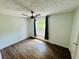 Clean bedroom features a modern ceiling fan, wood-look flooring, and natural light through a large window at 3748 Woodrose Ct, Snellville, GA 30039