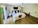 Bright bedroom showcases modern decor, sleek ceiling fan, and outdoor access to the private deck at 3748 Woodrose Ct, Snellville, GA 30039