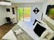 Modern bedroom features wood flooring, a ceiling fan, and sliding door access to a private deck with a pool view at 3748 Woodrose Ct, Snellville, GA 30039