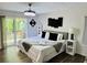 Bedroom featuring wood floors, a modern ceiling fan and access to a deck at 3748 Woodrose Ct, Snellville, GA 30039
