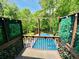 Private deck overlooking an in-ground pool and lush landscaping at 3748 Woodrose Ct, Snellville, GA 30039