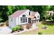 Charming home featuring large windows, a covered entry, landscaped yard, and a decorative fountain at 3748 Woodrose Ct, Snellville, GA 30039