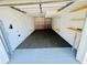 Spacious two car garage with carpeted flooring, interior storage, and an automatic door at 3748 Woodrose Ct, Snellville, GA 30039