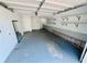 Spacious garage with shelving units, painted floor, and overhead lighting at 3748 Woodrose Ct, Snellville, GA 30039