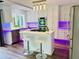 Modern kitchen features white cabinets, stainless steel appliances, a kitchen island with a gas stovetop and bar seating at 3748 Woodrose Ct, Snellville, GA 30039