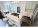 Modern kitchen features a center island with seating, stainless steel appliances, and ample cabinet space at 3748 Woodrose Ct, Snellville, GA 30039