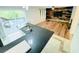 Modern kitchen with bar top, hardwood floors, sliding glass doors, and natural light at 3748 Woodrose Ct, Snellville, GA 30039