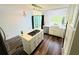 Well-lit kitchen with a center island, stainless steel appliances, white cabinets, and modern lighting at 3748 Woodrose Ct, Snellville, GA 30039