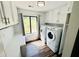 Laundry room featuring modern appliances, ample storage space, and a bright window at 3748 Woodrose Ct, Snellville, GA 30039
